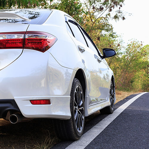 Toyota Corolla parked on the side of an asphalt road