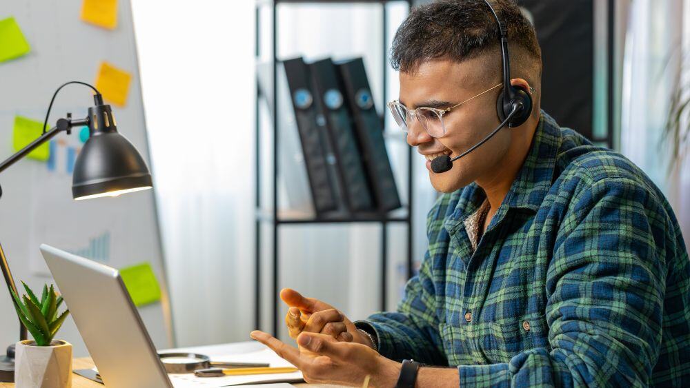 Work at home customer service agent talks enthusiastically via headset to a customer