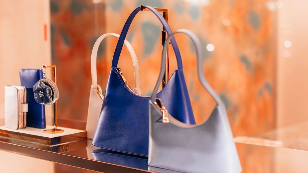 Luxury handbags on display in retail storefront