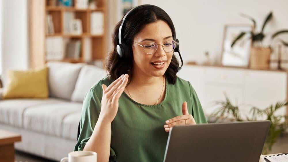 Competent and educated customer service agent talks a customer through the steps of her service in the comfort of her own home