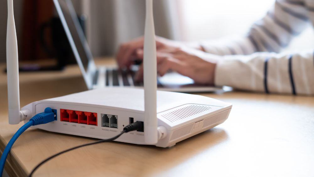 Detailed shot of an internet router with a laptop in the background