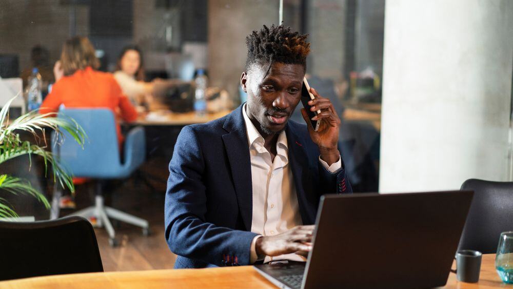 Businessman speaks on the phone in business environment