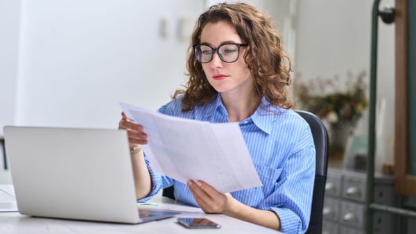 Customer sorts through paperwork to find her taxing information