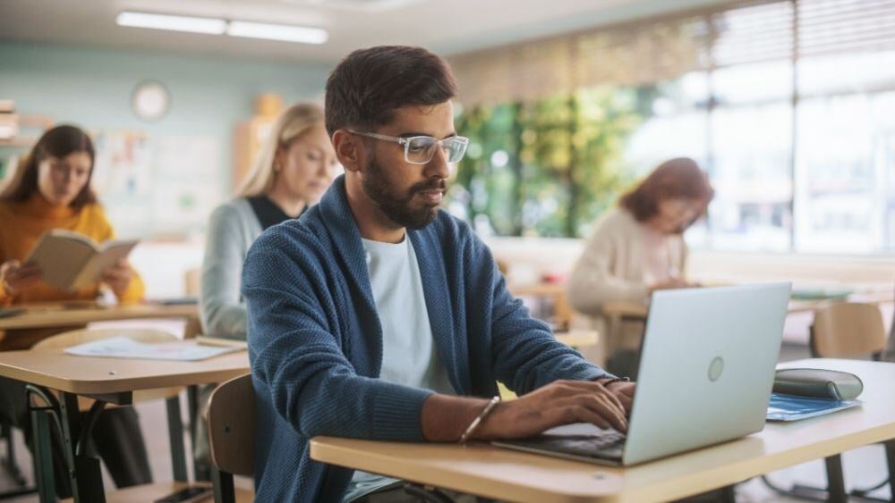 Focused student takes a test online in a studious environment