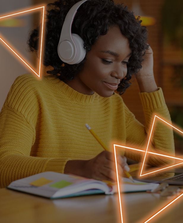 Young Black customer service representative takes notes while on a call