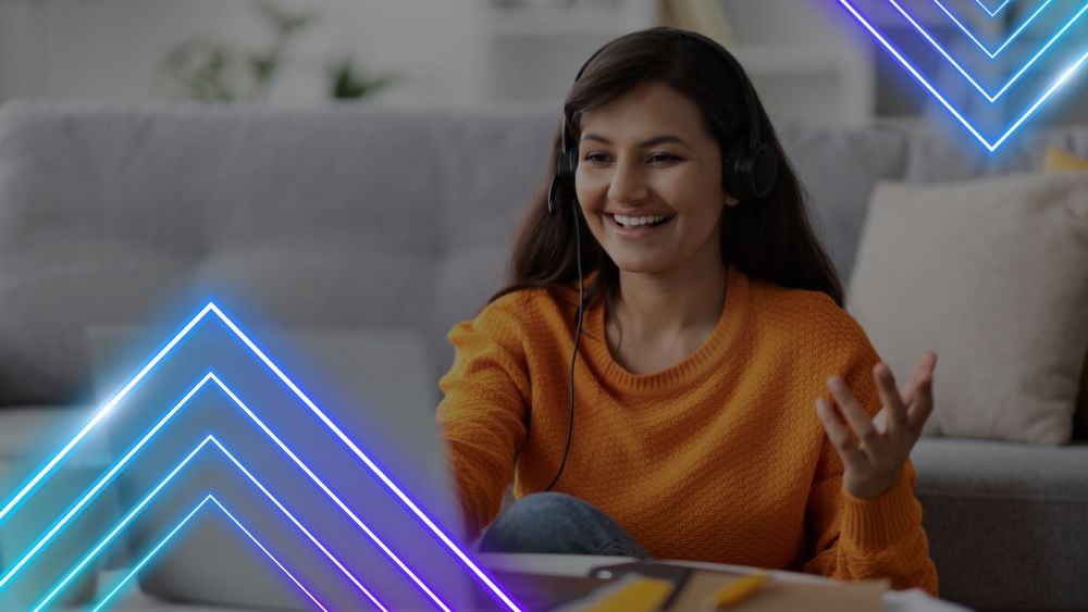 Young customer service representative talks cheerfully with a customer via voice call in her living room at home