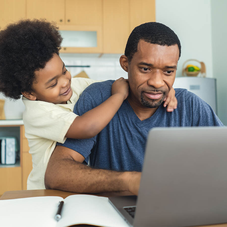 Dad with son in front of a computer