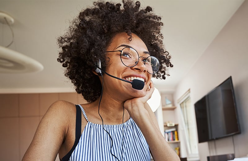 customer service agent smiling while wearing a headset