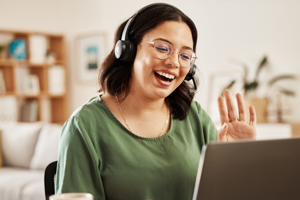Happy agent waving at the computer