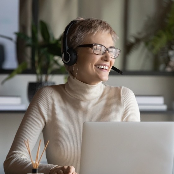 Working Solution Agent Smiling at while working on computer